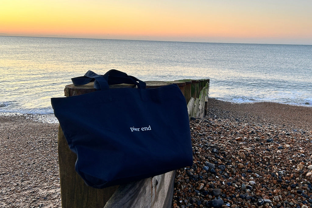  XL navy canvas tote sat at the beach at sunrise