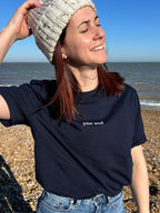 Female customer wearing the Navy crewneck tshirt on the beach